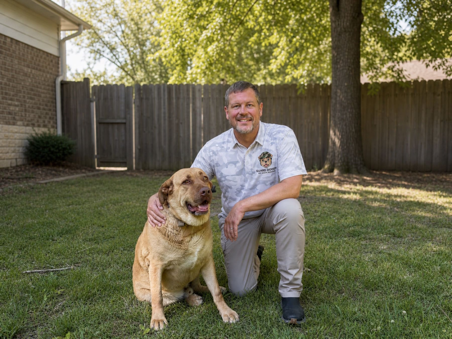 Christopher Glass of Guard Doody with a dog in a backyard